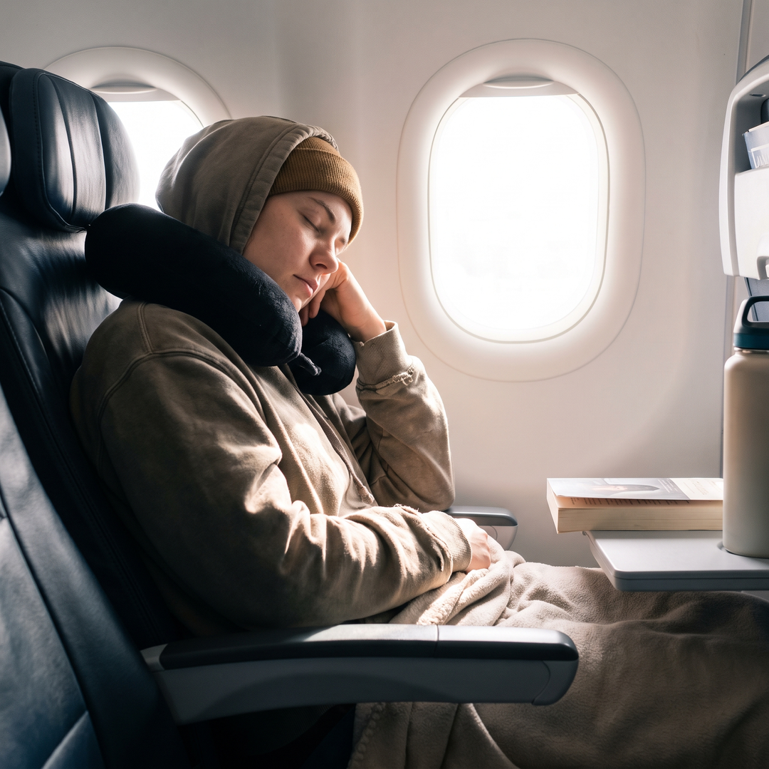 Airplane travel comfort scene with U-shaped neck support pillow, alternate