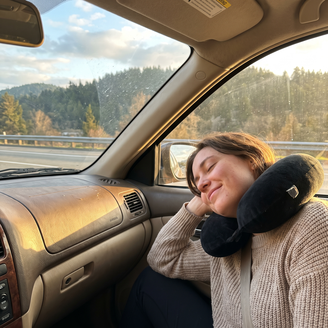 Passenger relaxing during a car ride using a U-shaped neck support pillow