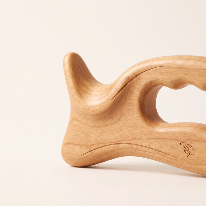 Close-up of the ergonomic grip ridge on the wooden massage tool
