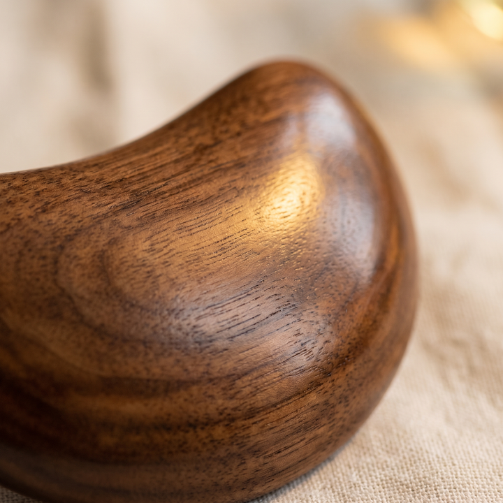 Polished natural wood finish of the massage tool