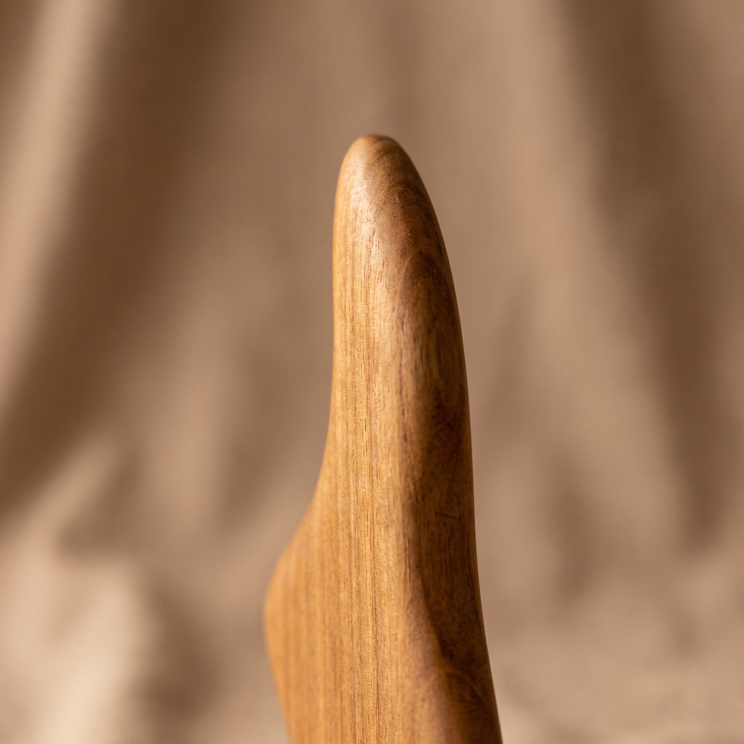 Wooden body scraper side profile showing smooth contour edge