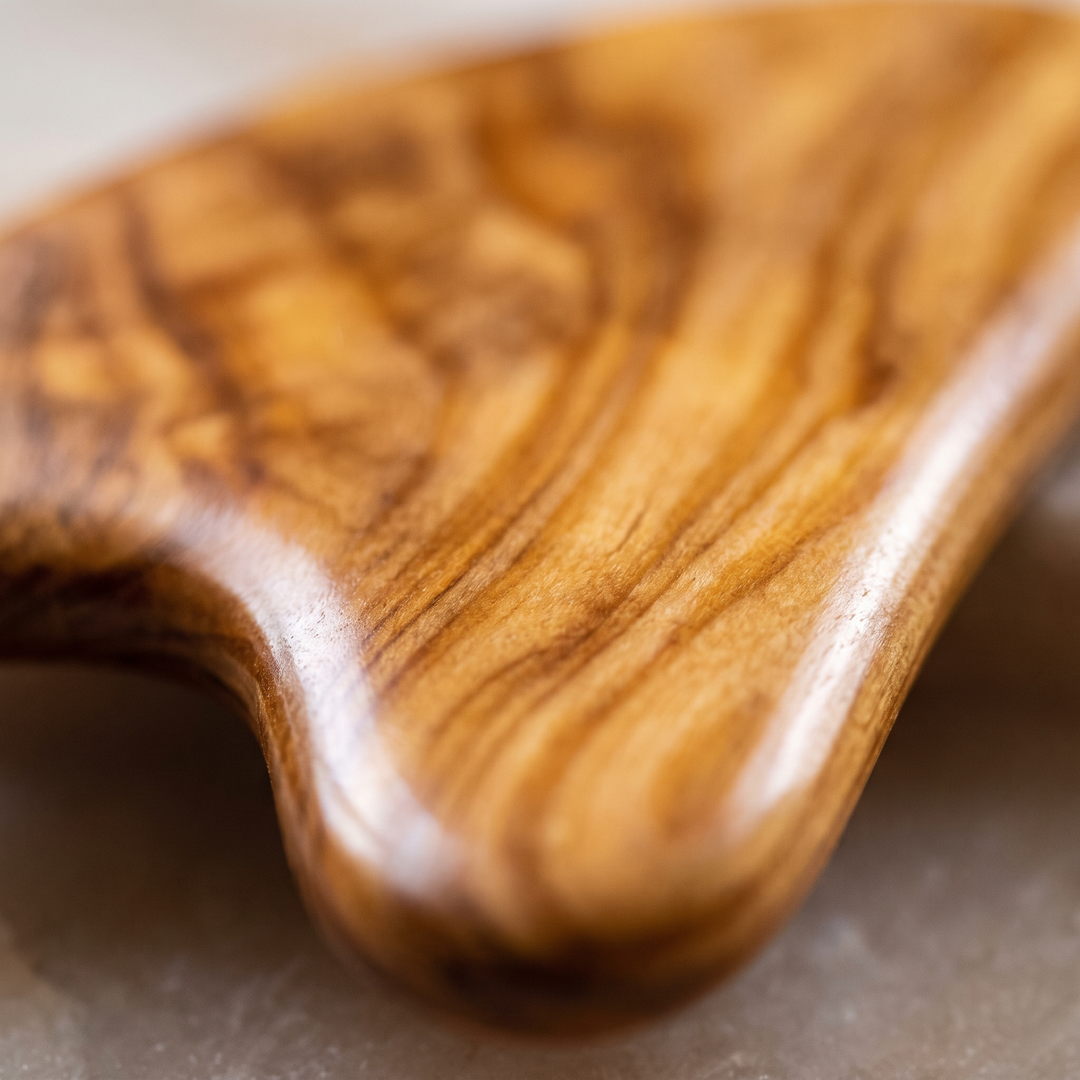 Close-up of natural wood grain texture on wellness massage tool