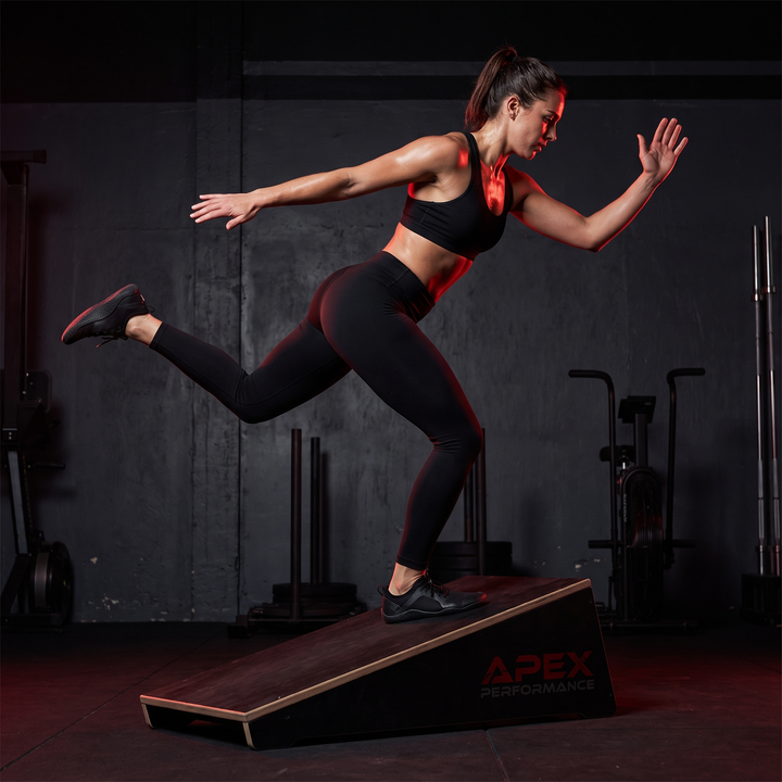 Single-leg balance training on the PHYSIOATHLETX wooden incline stretch board