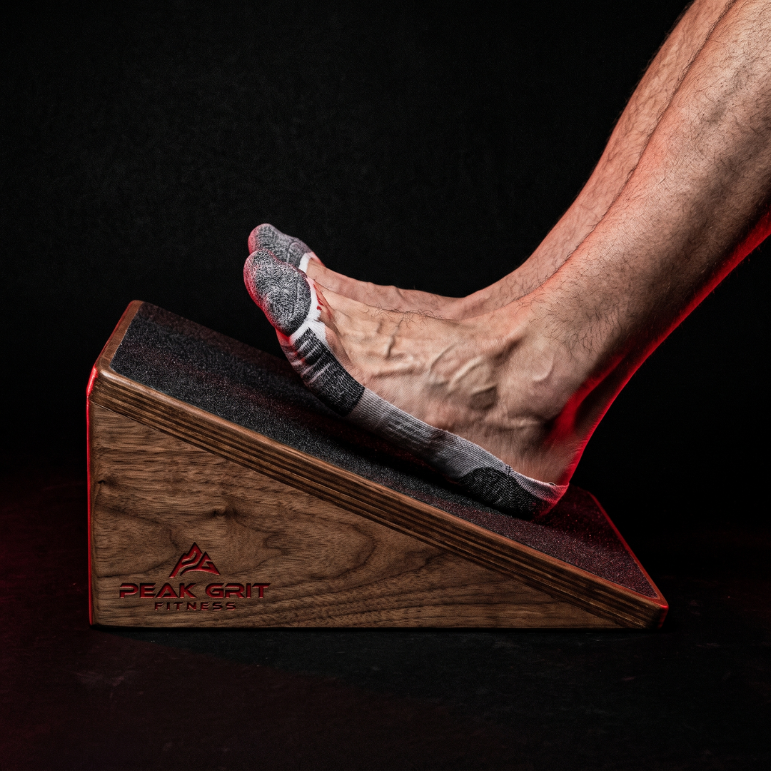 Feet secured on the non-slip surface of the PHYSIOATHLETX wooden incline board during a calf stretch