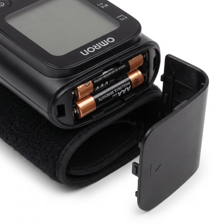 Battery compartment of digital wrist blood pressure monitor showing AAA batteries