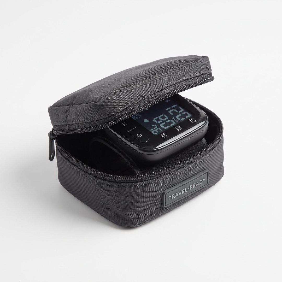 Digital wrist blood pressure monitor in compact storage case for travel