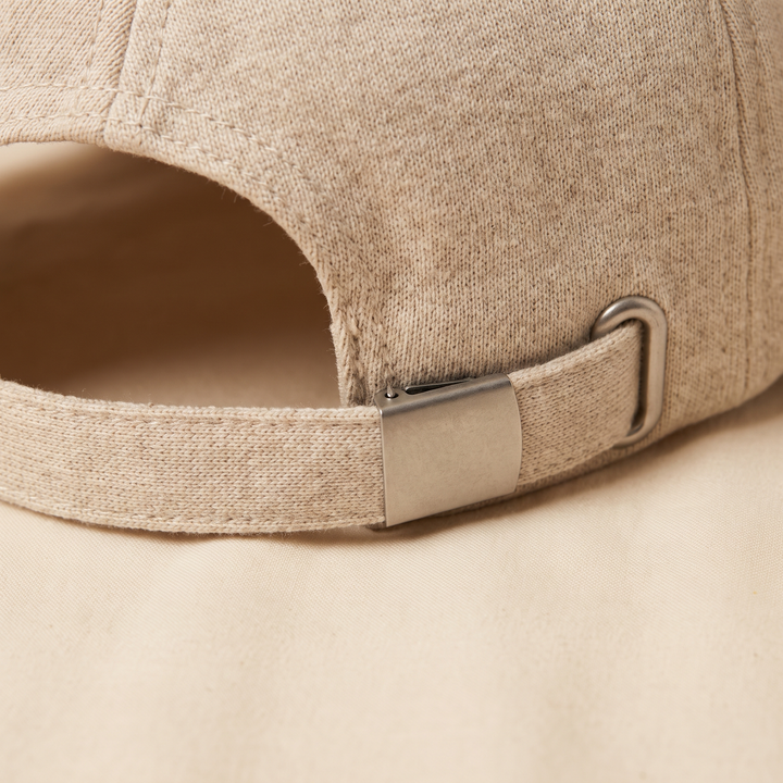 Close-up of the adjustable strap and buckle closure on the scalp care cap
