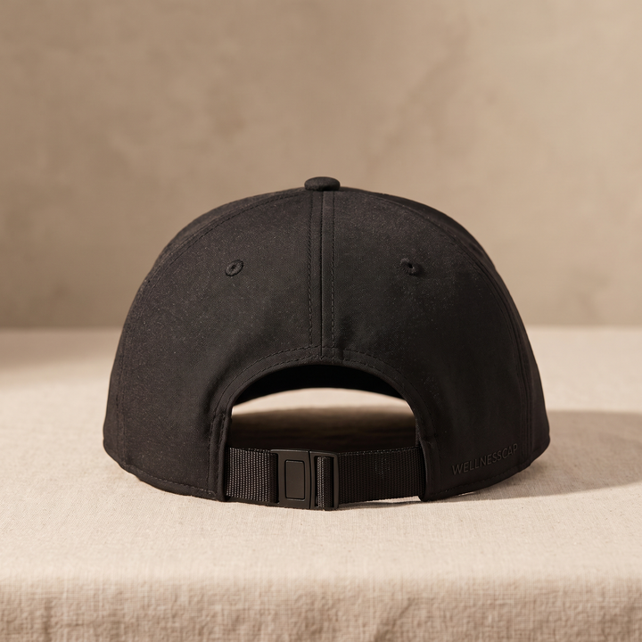 Black LED scalp care cap rear view showing adjustable strap and closure