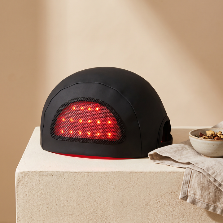 Black LED scalp care cap side view showing soft mesh panel with red LED array