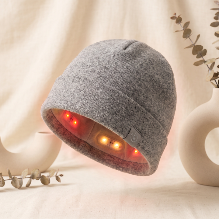 Grey red light LED cap for scalp wellness rituals, front three-quarter view
