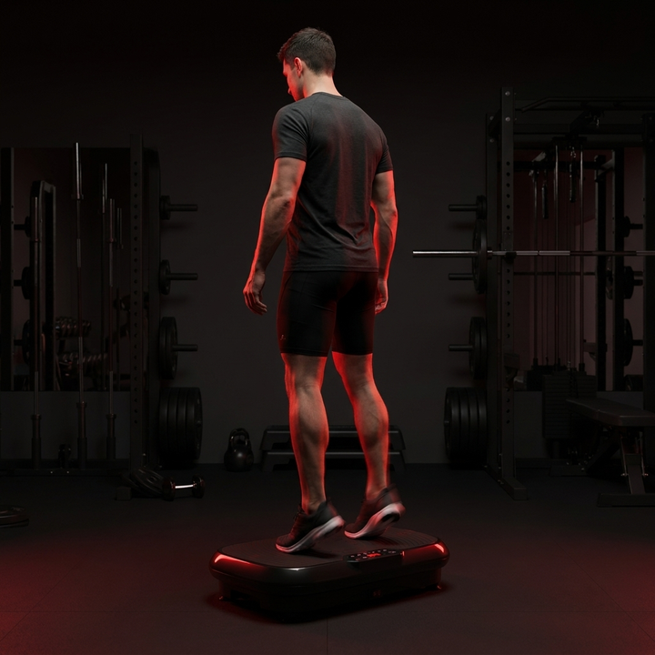 PHYSIOATHLETX vibration plate exercise machine - man performing calf raises on toning workout platform