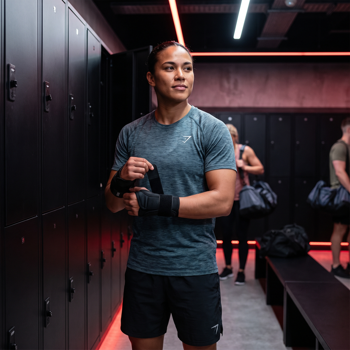 Athlete adjusting wrist support brace strap before workout